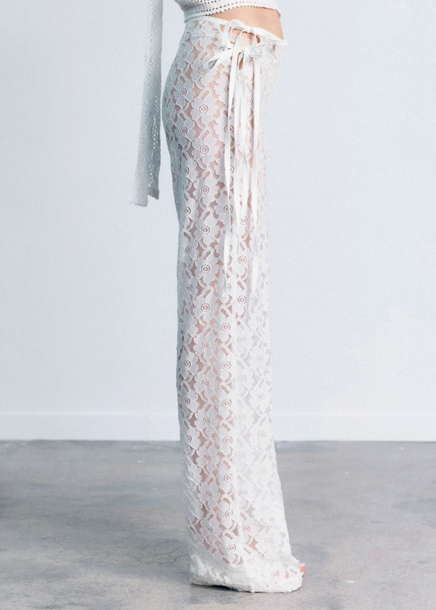 KABE SHOP INC white lace trousers with a strappy handkerchief waistband and a fitted silhouette in a side view