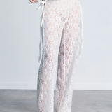 KABE SHOP INC white lace trousers with a strappy handkerchief waistband and a fitted silhouette on a model