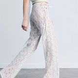 KABE SHOP INC white lace trousers with a strappy handkerchief waistband and a fitted silhouette on a model.