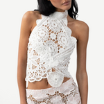 Model wearing a KABE SHOP INC white cotton Vanilla Top with intricate crochet and lace patchwork details.