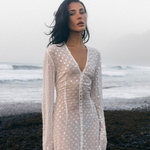 KABE SHOP INC Mirror Dress in sheer white fabric with silver embellishments worn by a model on a misty beach