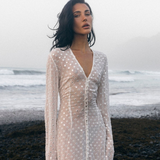 KABE SHOP INC Mirror Dress in sheer white fabric with silver embellishments worn by a model on a misty beach
