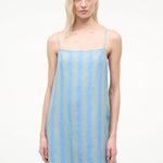 The Laura Mini Dress is a sleeveless mini dress for warm-weather dressing featuring thin shoulder straps and vertical blue and green stripes.