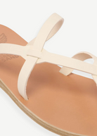 KABE SHOP INC Armos sandals featuring cream leather straps and a tan footbed in a classic minimalist design.