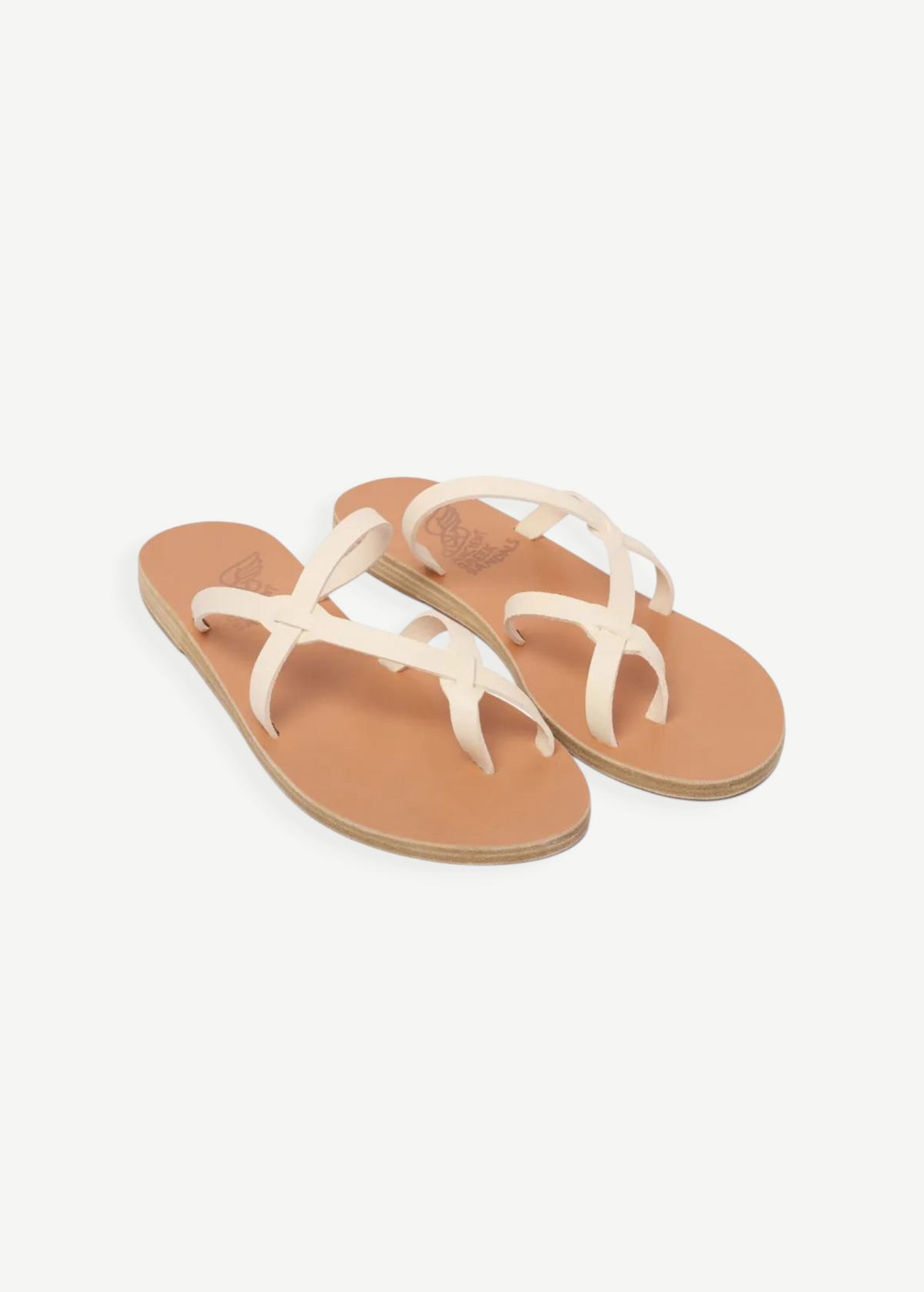 KABE SHOP INC Armos sandals featuring off-white leather straps and a tan flat sole in a classic thong design.