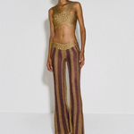 Model wearing KABE SHOP INC Cher Set featuring a gold metallic woven crop top and matching striped flared trousers.