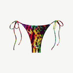 The Praia Bottom is a tie-dye mystic parallelo bikini bottom with adjustable side strings, showcasing a vibrant blend of red, yellow, green, and black on a white base. Made from recycled nylon swimwear fabric, this eco-friendly piece offers minimal back coverage for a colorful and sustainable beach style.