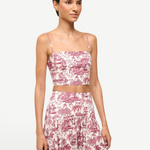 Model wearing KABE SHOP INC Federico cropped tank top in white and burgundy toile de jouy print with spaghetti straps