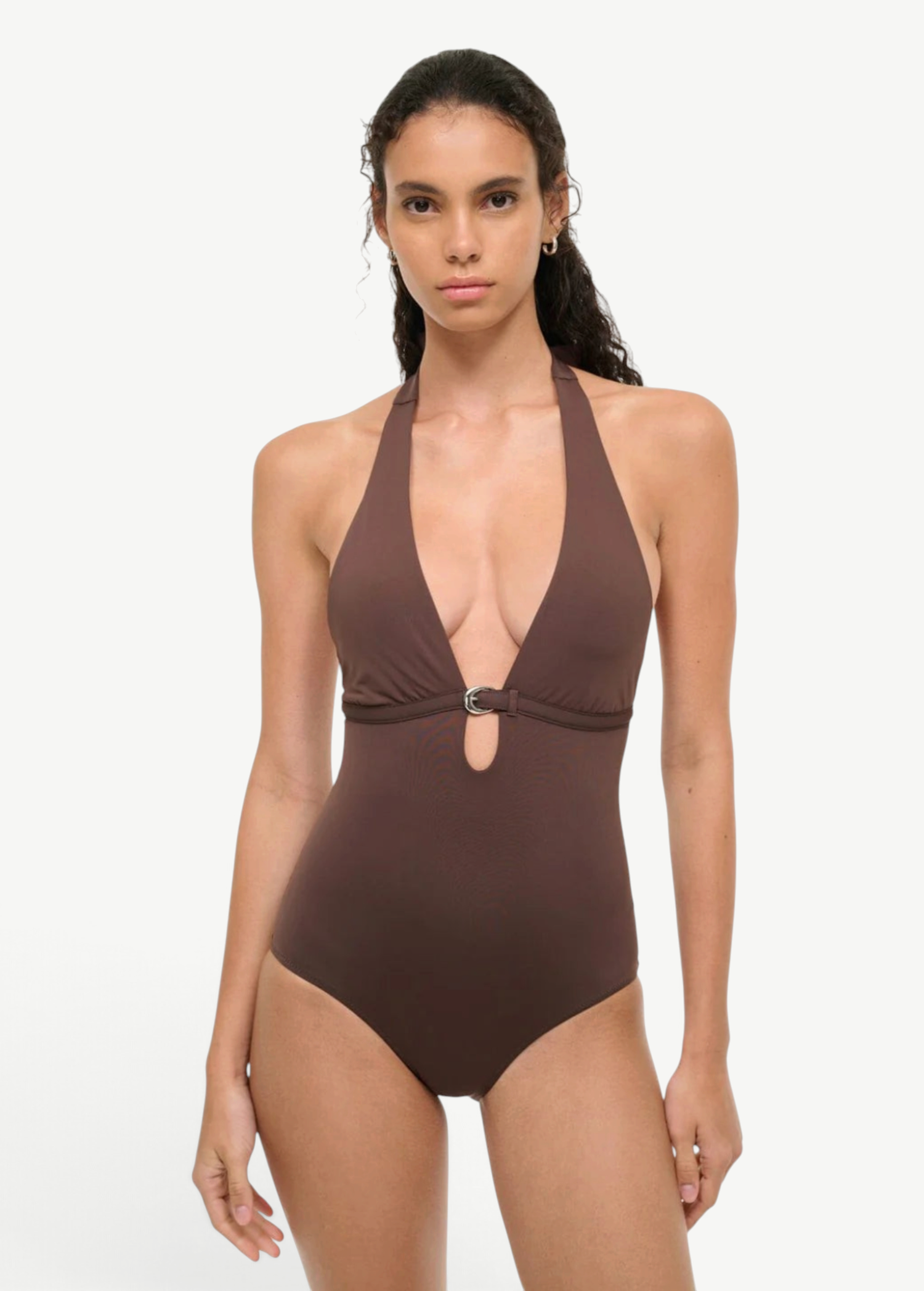 A woman wearing a deep brown La Jolla Swimwear La Jolla One Piece, a halter-style swimsuit featuring a silver ring detail at the center cutout.
