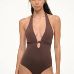 A woman wearing a deep brown La Jolla Swimwear La Jolla One Piece, a halter-style swimsuit featuring a silver ring detail at the center cutout.