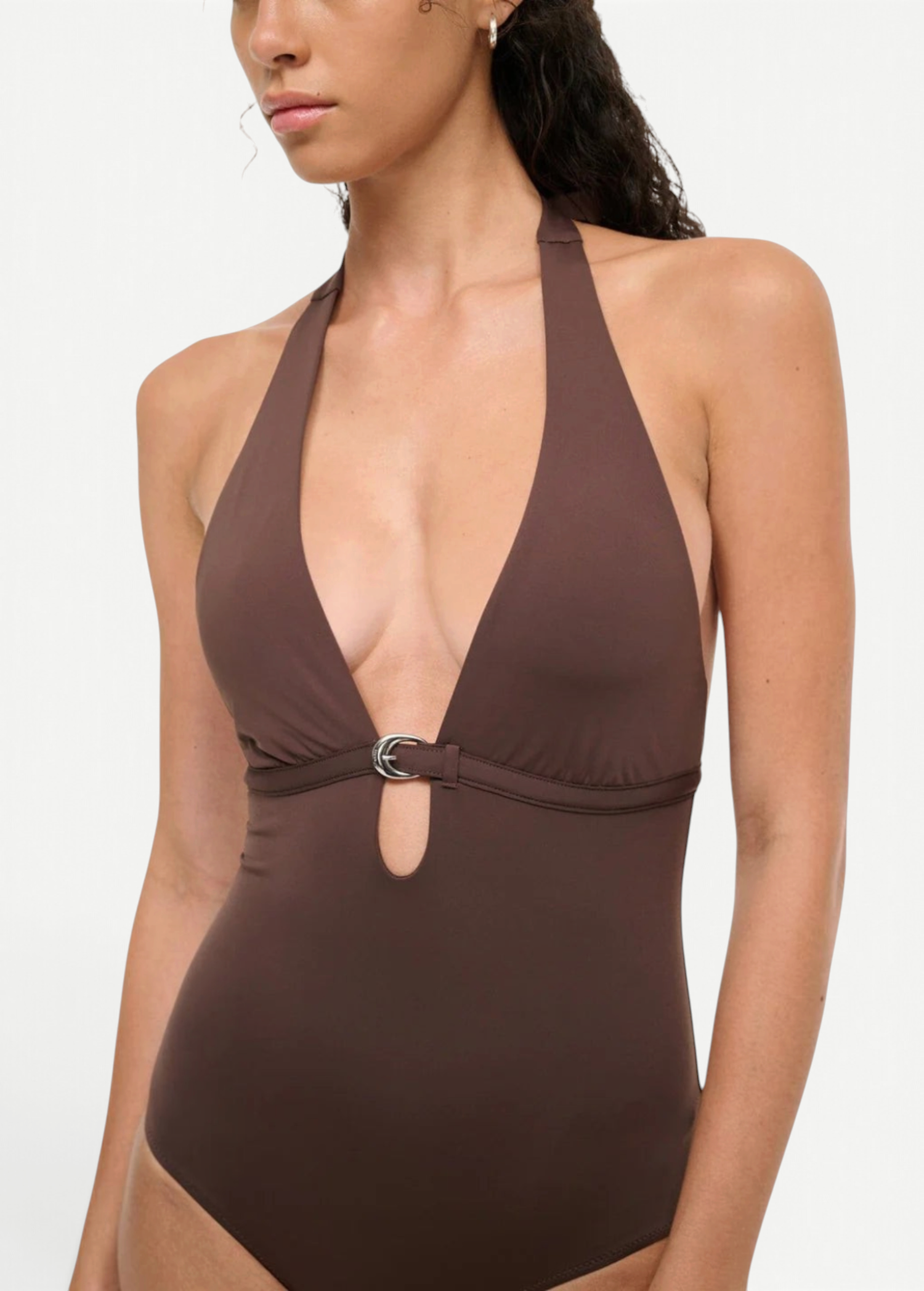A brown La Jolla Swimwear one-piece swimsuit with a deep halter neckline and a silver crescent-shaped hardware accent at the center.