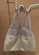 KABE SHOP INC Elziver bag featuring a geometric woven pattern in brown, green, and cream with striped handle details.