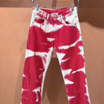 Red and white Tie Dye Jeans in a vintage style on a clothes hanger.