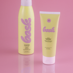 KABE SHOP INC SPF 50 sunscreen lotion and continuous spray mist in yellow packaging on a pink background