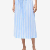 The Shore Skirt is a light blue and white vertical-striped stretch poplin midi skirt featuring a gathered elastic paper-bag waist with a drawstring.