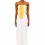 Wearing The Triangle Top—a strapless, yellow-to-white gradient piece crafted with sustainable Marrakech fashion techniques—and high-waisted, wide-leg white pants, the person stands facing forward against a plain white background.