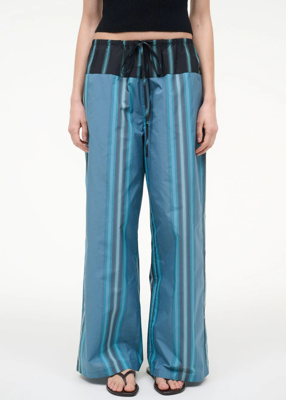 Mateo Pant wide-leg trousers featuring a blue and dark green vertical stripe pattern with a black drawstring waistband.