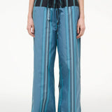 Mateo Pant wide-leg trousers featuring a blue and dark green vertical stripe pattern with a black drawstring waistband.
