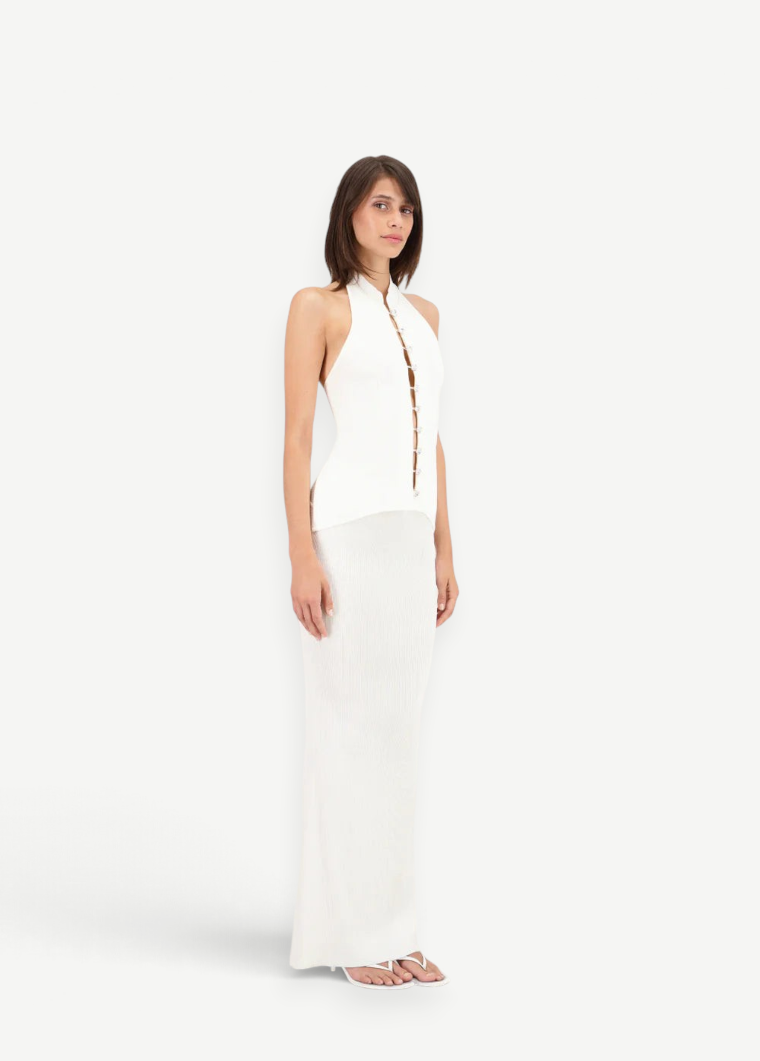 Model wearing KABE SHOP INC Classic Malageta white maxi skirt and matching sleeveless button-down halter top