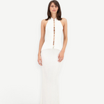 Model wearing a KABE SHOP INC white sleeveless top with front button detail and a matching floor-length maxi skirt.