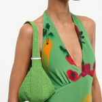 KABE SHOP INC Demy shoulder bag in bright green beaded texture worn over the shoulder with a matching floral dress