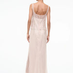 Back view of the Greta Dress, a pale pink sheer maxi dress for special occasions featuring a sleeveless silhouette, scoop back, and metallic disc embellishments at the waist.