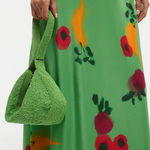KABE SHOP INC Demy shoulder bag in green beaded texture held by a model wearing a matching floral print dress