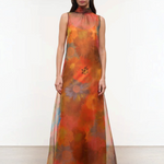 Sleeveless, floor-length Albee Dress with a high mock neck, featuring an abstract orange, red, and yellow floral print in a sheer fabric.
