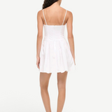 Back view of KABE SHOP INC Dena white cotton poplin mini dress with fitted bodice and drop waist on a model