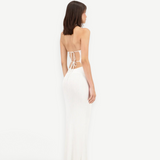 Model wearing a white KABE SHOP INC Classic Malageta maxi skirt with a matching backless tie-up top