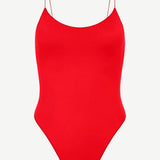 The C One Piece is a vibrant red one-piece swimsuit made from recycled nylon, featuring thin spaghetti straps and a high-cut leg, shown against a plain white background.