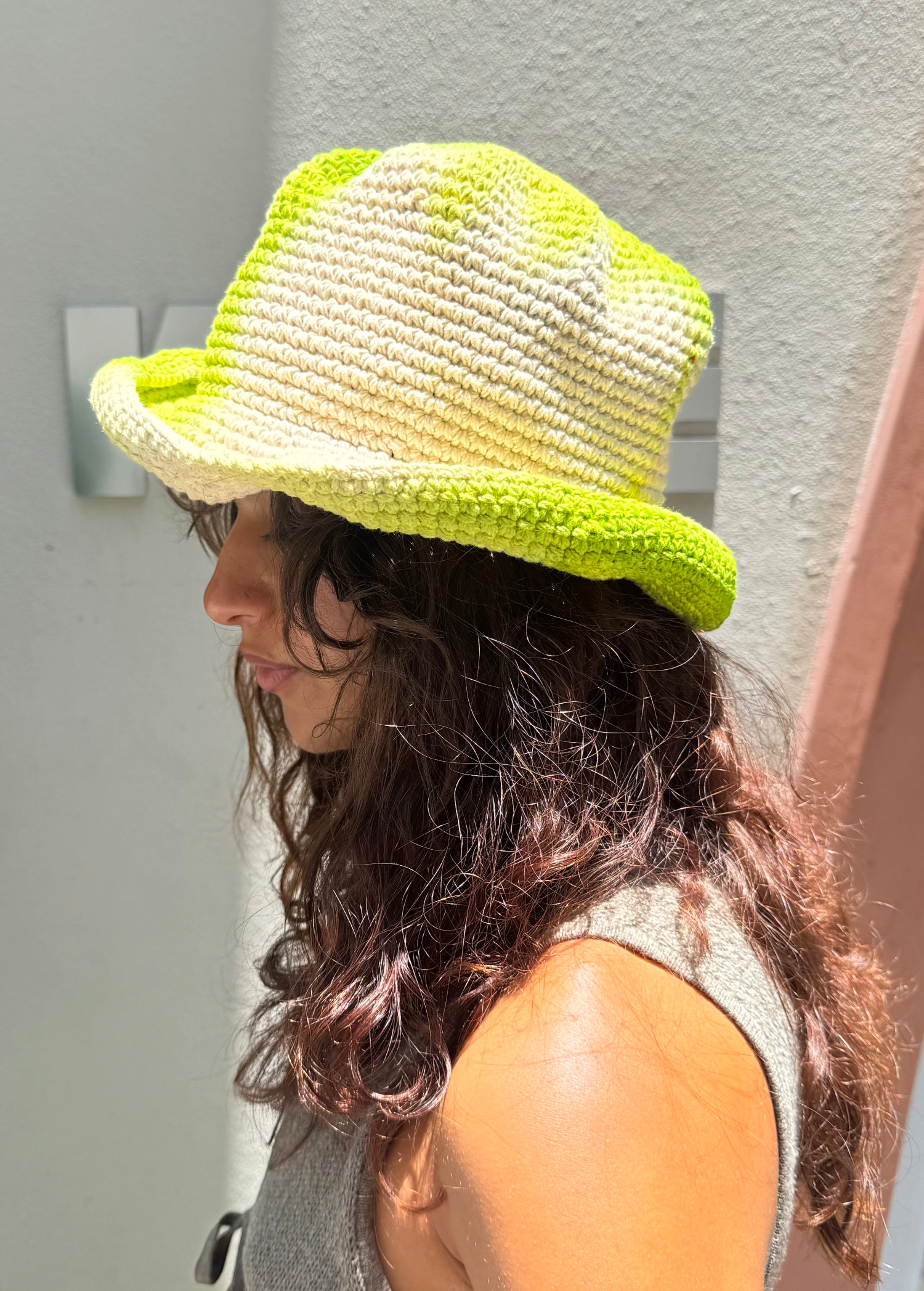 KABE SHOP INC Pora crochet bucket hat in lime green and cream tie-dye worn by a woman outdoors