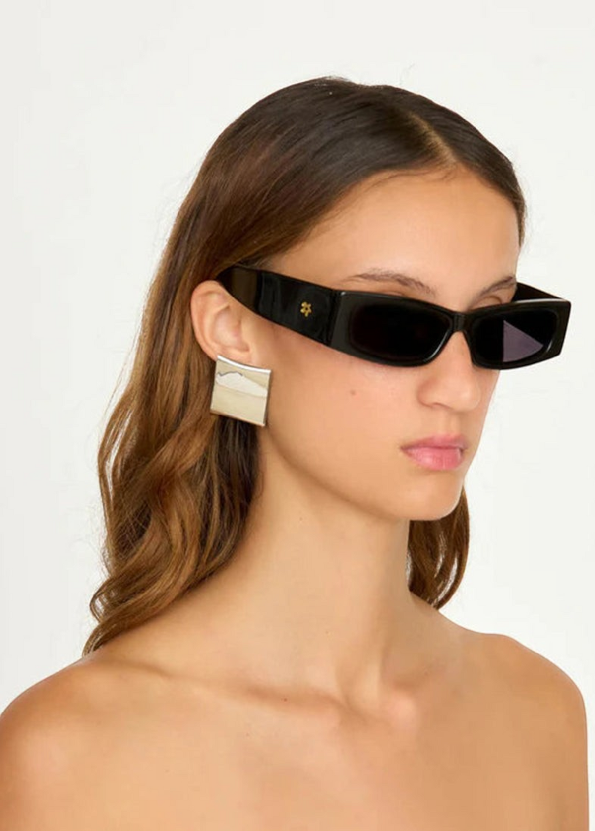 Model wearing KABE SHOP INC Colbi Earrings, featuring a bold silver-plated geometric square design
