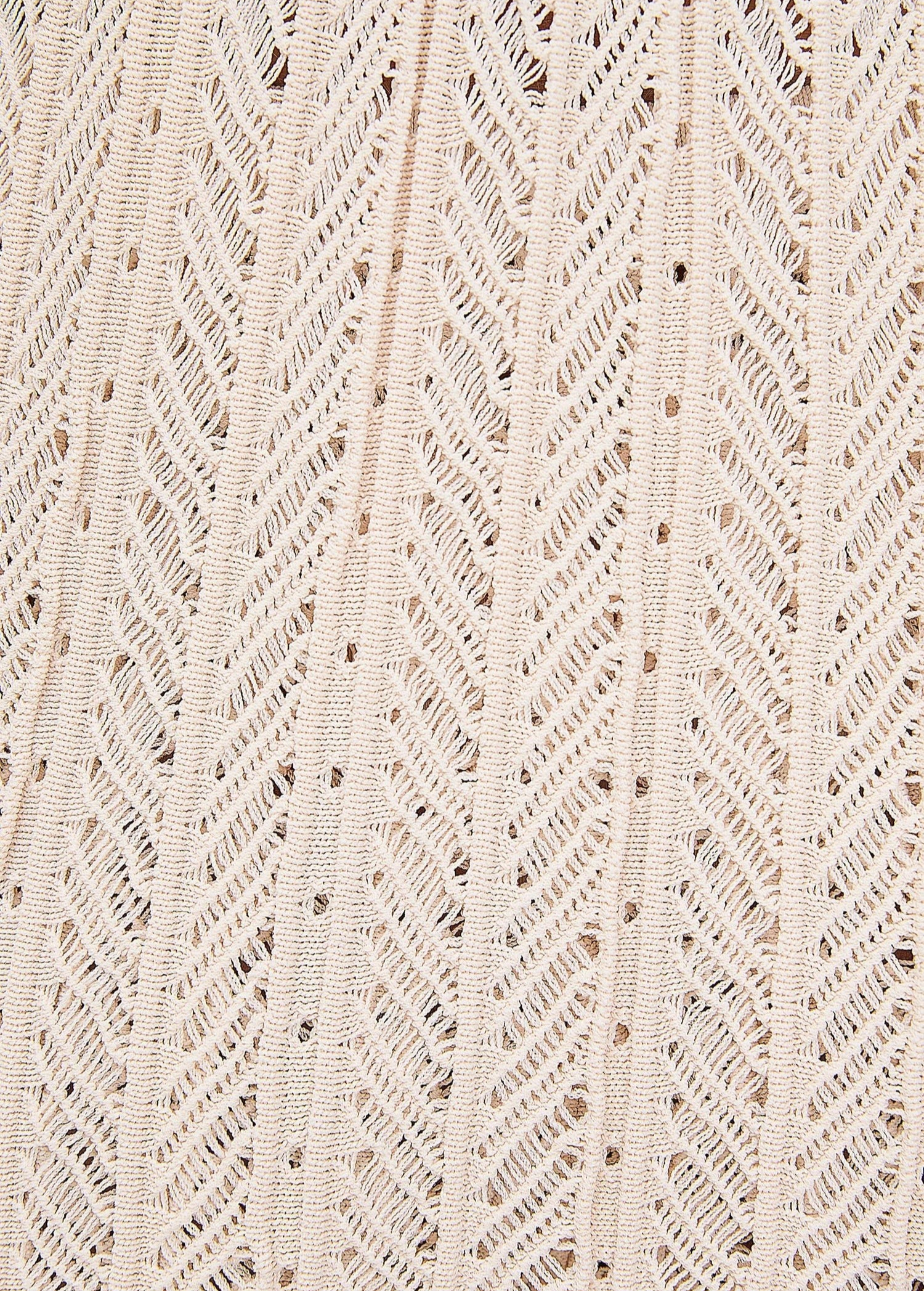 Close-up of the beige knit fabric of the KABE SHOP INC Christine Short featuring a detailed chevron texture.