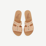 KABE SHOP INC Apteros slide sandals in tan leather with silver and gold metallic eyelet hardware details.