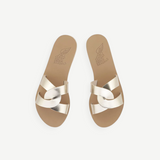 KABE SHOP INC Desmos sandals in metallic gold leather with elegant interlocking straps and a flat tan sole.