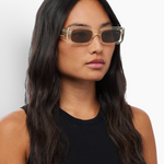Model wearing KABE SHOP INC Verve rectangular sunglasses with translucent frames and dark lenses