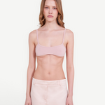 KABE SHOP INC minimalist pale pink bralette top with thin straps worn by a model against a neutral background