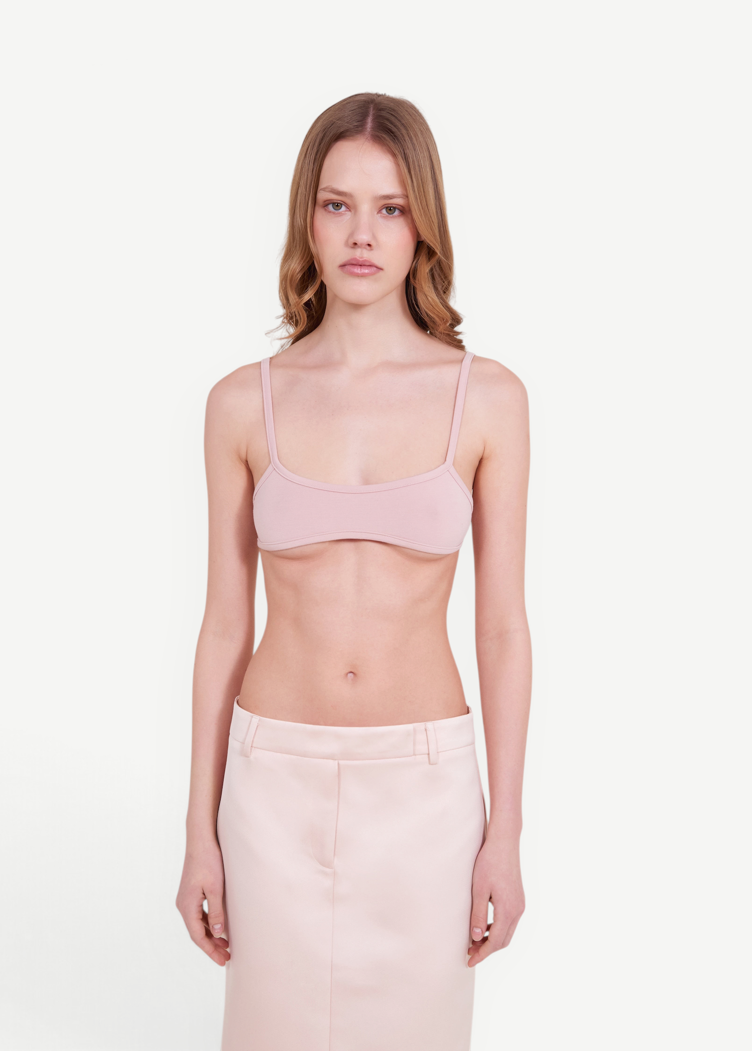 KABE SHOP INC minimalist pale pink bralette top with thin straps worn by a model against a neutral background
