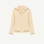 Cream-colored Iris Top cardigan with a relaxed silhouette, featuring a notched collar and dark brown blanket stitching on the collar, cuffs, and hem pockets.