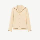 Cream-colored Iris Top cardigan with a relaxed silhouette, featuring a notched collar and dark brown blanket stitching on the collar, cuffs, and hem pockets.