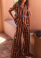 KABE SHOP INC Nera wide leg pants featuring a brown, black, and white tribal ikat print with blue crochet trim