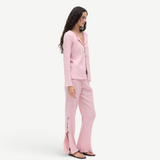 KABE SHOP INC Malaika pants in light pink with a textured finish, straight-leg silhouette, and side button detailing.