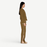 Model wearing KABE SHOP INC Malaika olive green straight-leg pants with side slit and contrast stitching