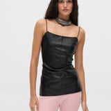 A person wearing a minimalist, body-hugging Xena Top in black faux-leather with thin straps and a wide, sparkling silver choker necklace.