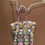 KABE SHOP INC Kanpur bag featuring a geometric multi-colored mesh pattern and striped fabric handles