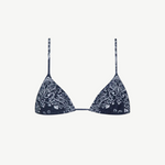 The Equator Top is a navy blue triangle bikini top with thin straps and a white paisley floral pattern. Made from ECONYL regenerated nylon, this adjustable bikini top offers a simple, minimalistic design for an effortlessly chic look.