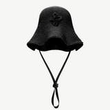 KABE SHOP INC black woven straw bucket hat with a decorative chain strap detail and wide brim