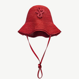 KABE SHOP INC red woven straw hat bag with a structured bucket silhouette and decorative braided emblem