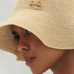 KABE SHOP INC beige woven bucket hat with embroidered monogram detail worn by a model